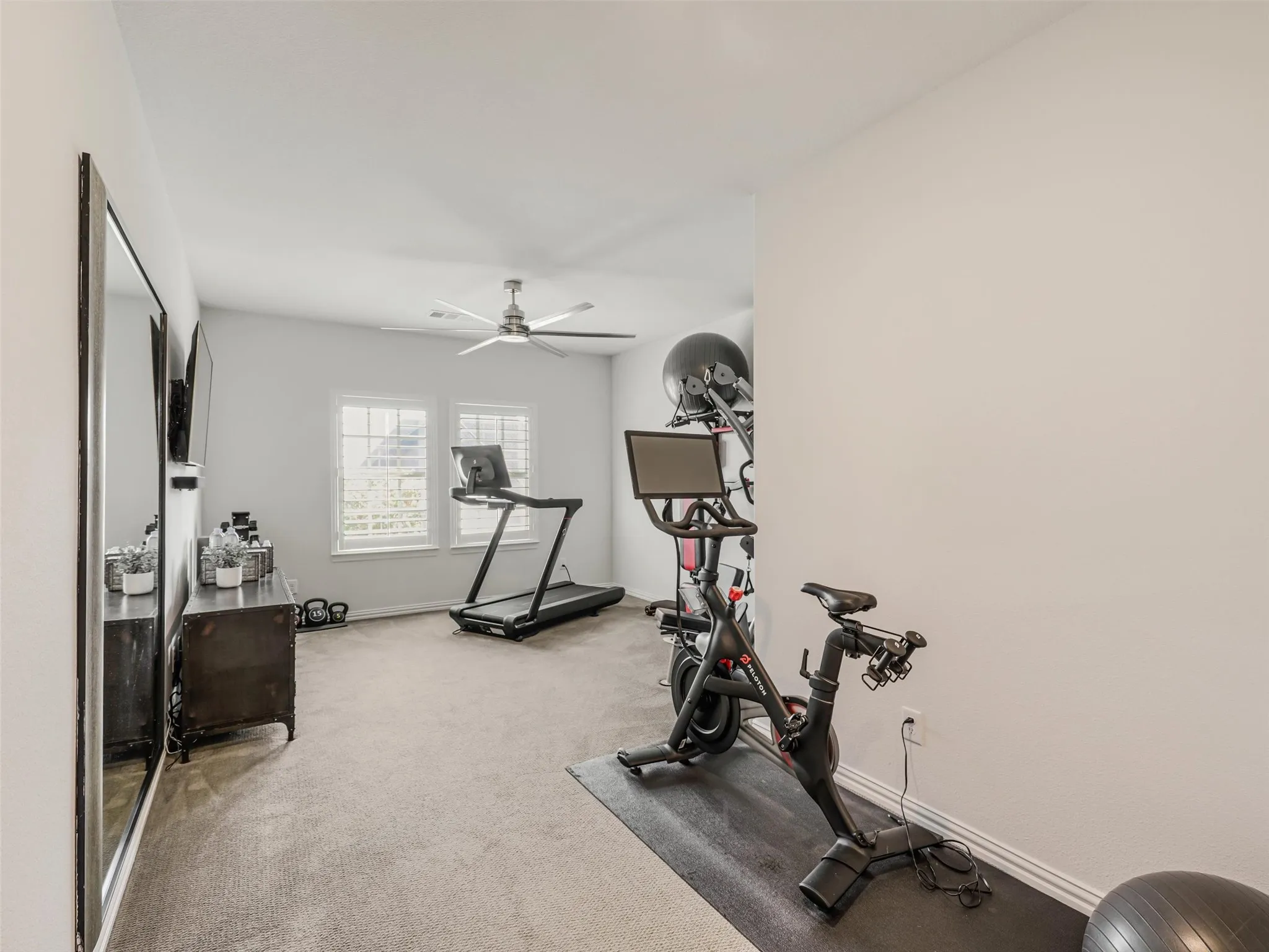 A separate home gym offers the convenience of working out without ever leaving home. • White oak flooring throughout the first floor
• Foyer: Restoration Hardware chandelier
• Dining room: custom carpentry and Williams Sonoma chandelier
• Office: custom built-ins
• Game room: custom carpentry and dry bar
• Media room: Epson 4K projector