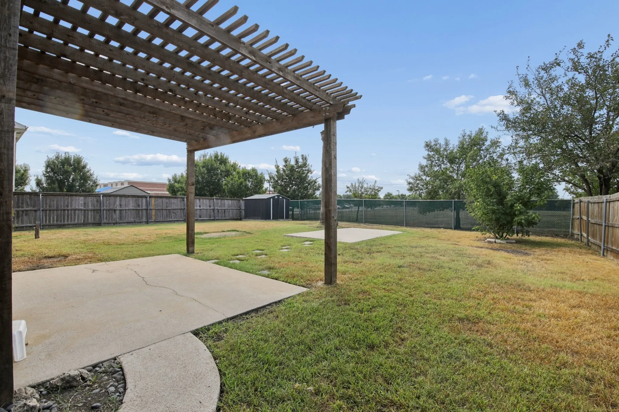 The spacious back yard includes two patios, one with a pergola, plus a shed and plenty of space to roam!
