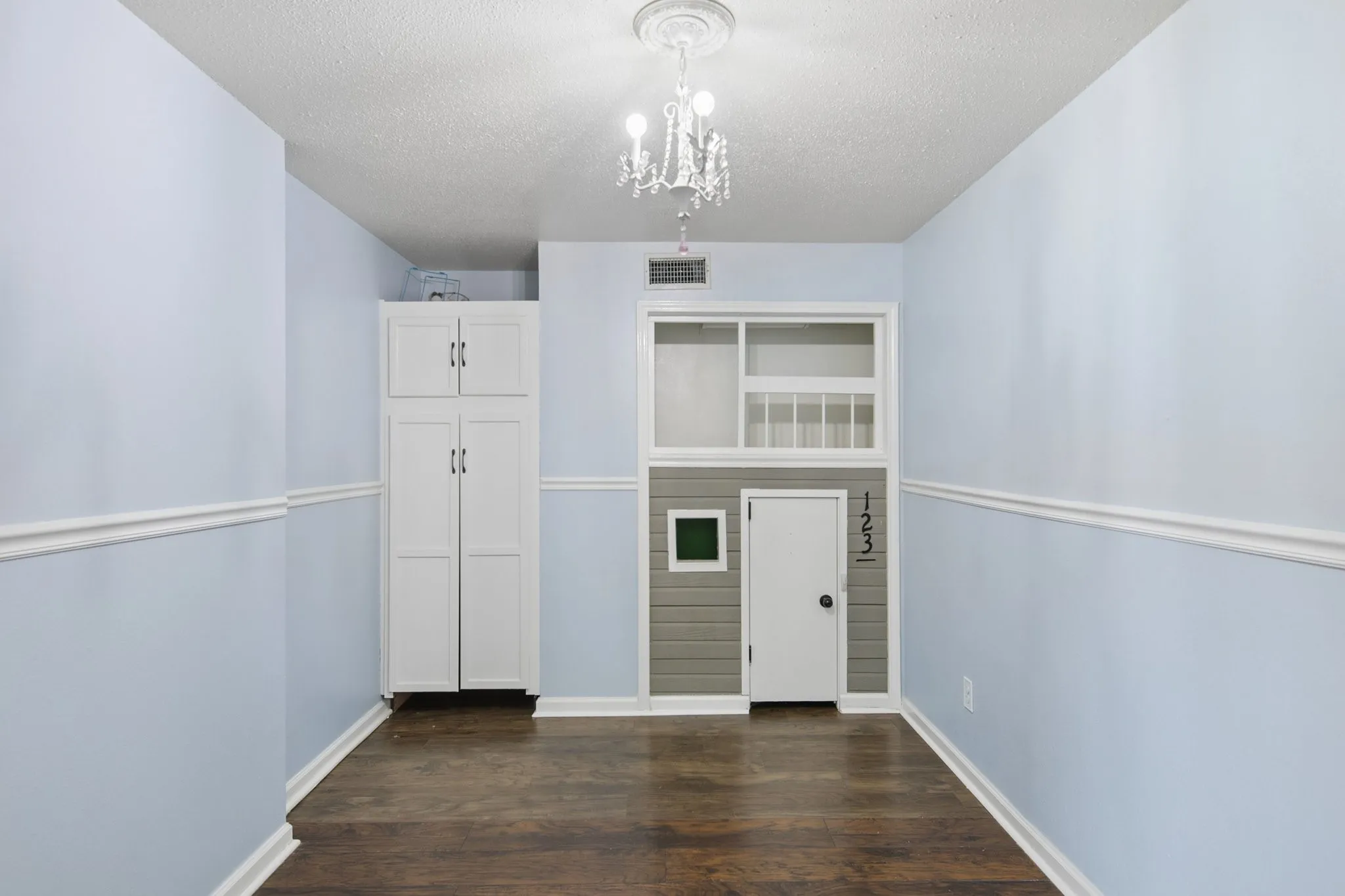 The private office (previously used as a playroom) at the front of the home features built-in cabinets and a playhouse!