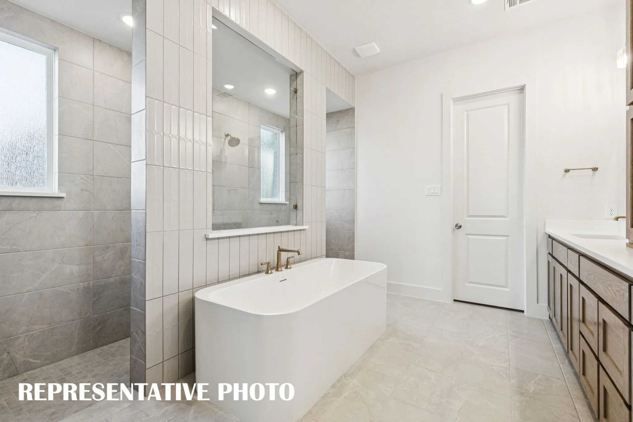 Our Addison III plan offers our signature owner's bath with freestanding tube and double walk through shower!  REPRESENTATIVE PHOTO