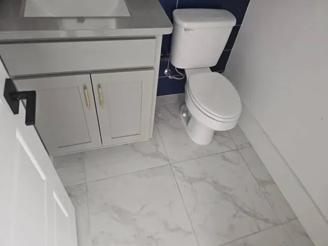White tile flooring with subtle gray veining