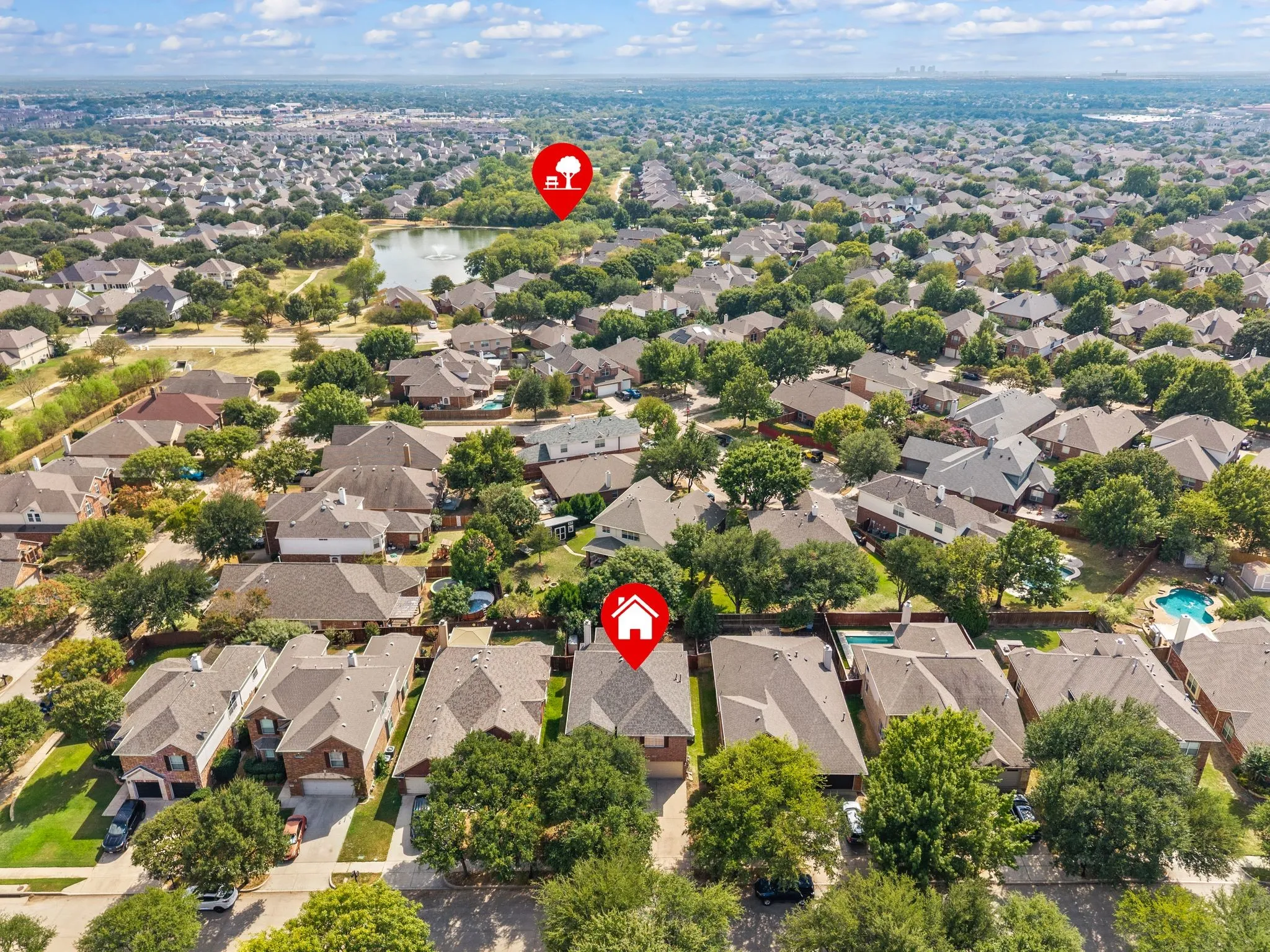 Aerial perspective showcasing a residential neighborhood with a prominent water feature