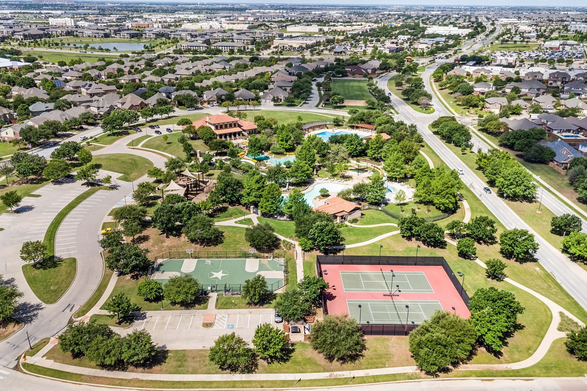 Expansive community amenities featuring a clubhouse, multiple swimming pools, tennis courts, and a basketball court