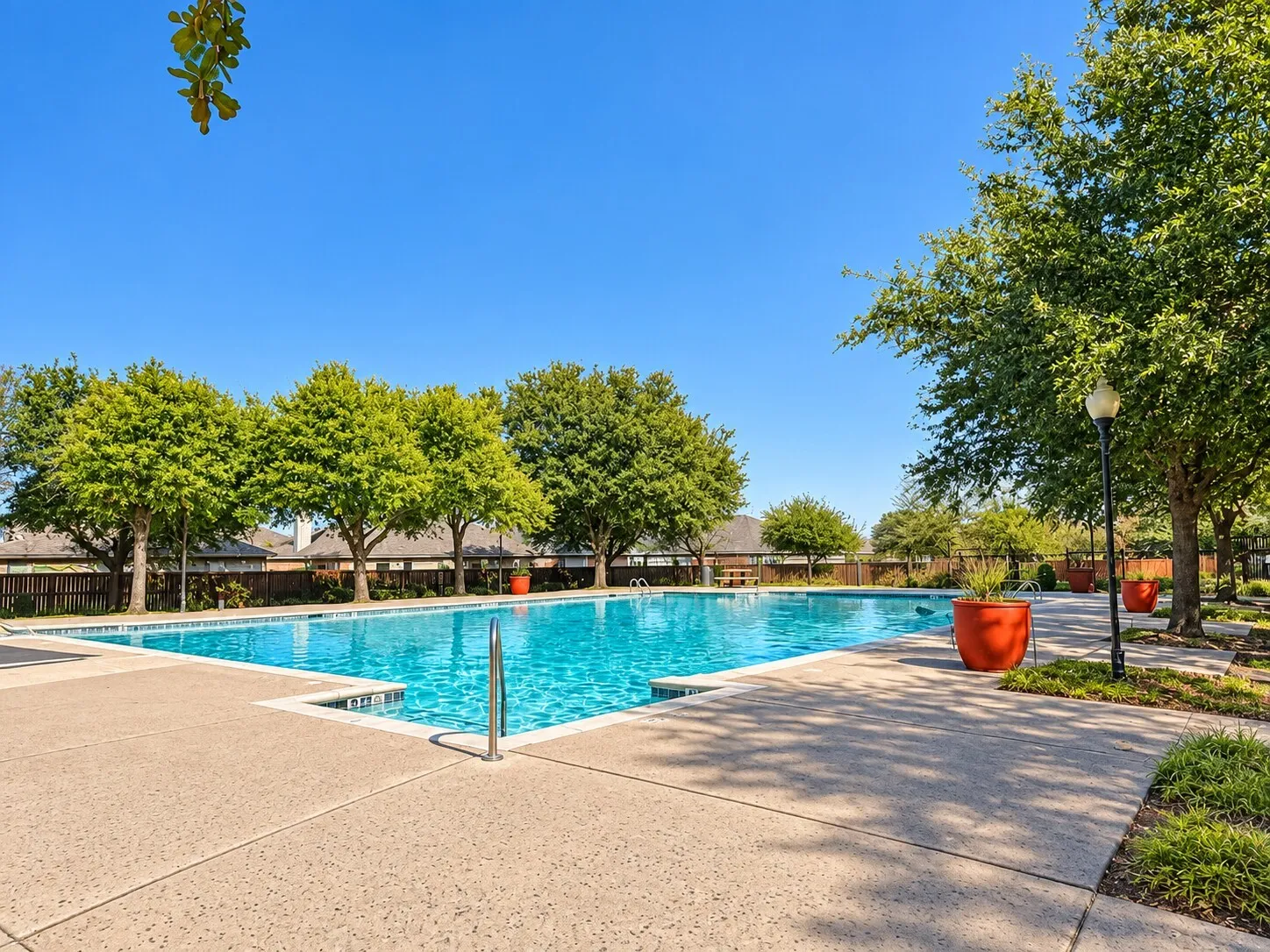 Outdoor swimming pool with integrated steps and a surrounding concrete deck