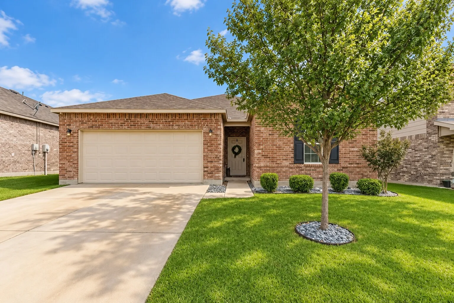 Brick exterior with a gabled roof and attached garage