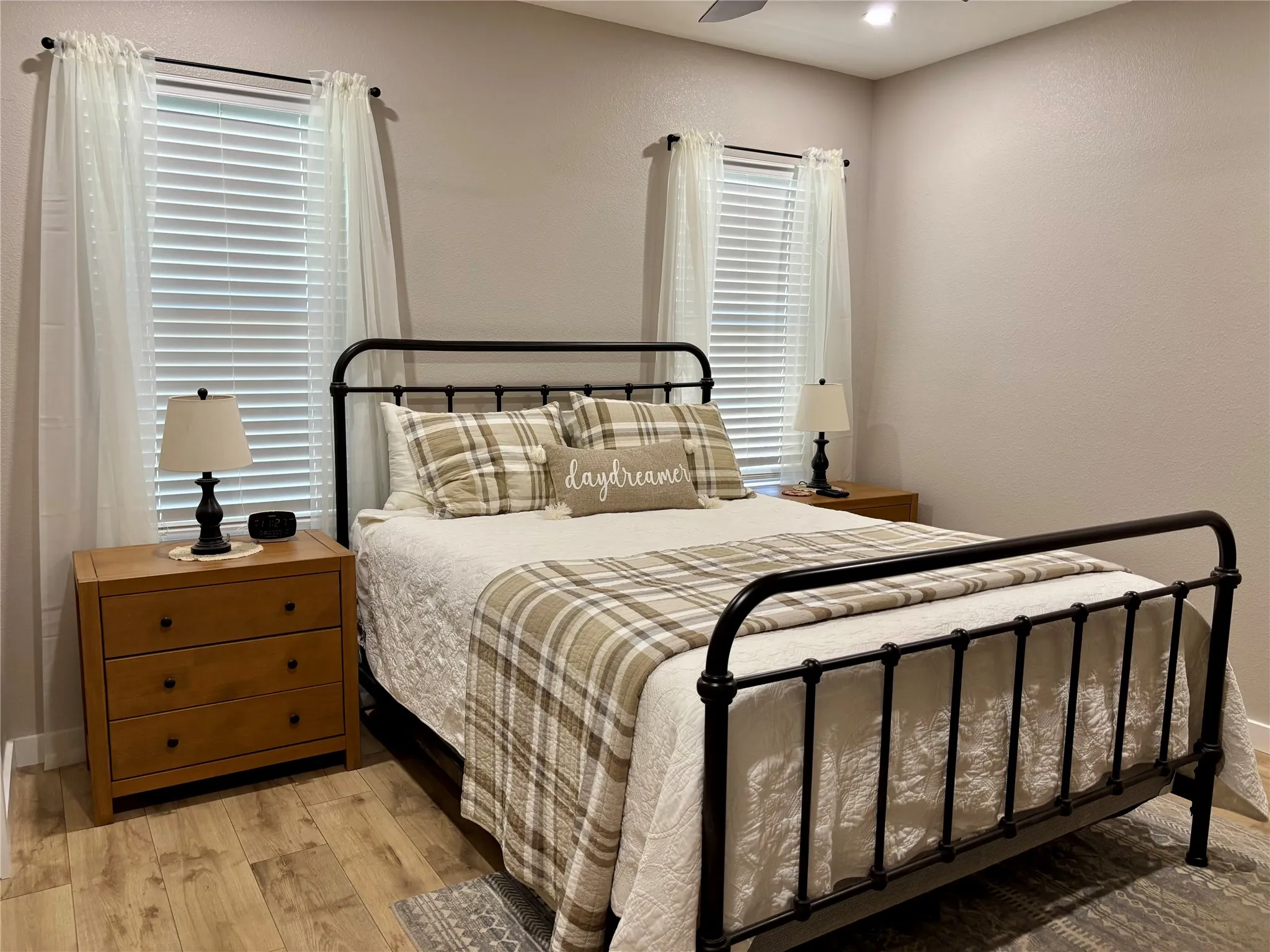 Wood-finish flooring throughout, with a ceiling fan overhead