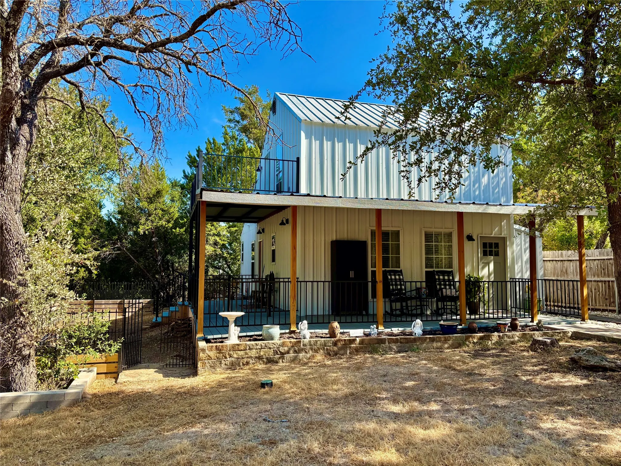 View showing front and side covered porches and balcony.