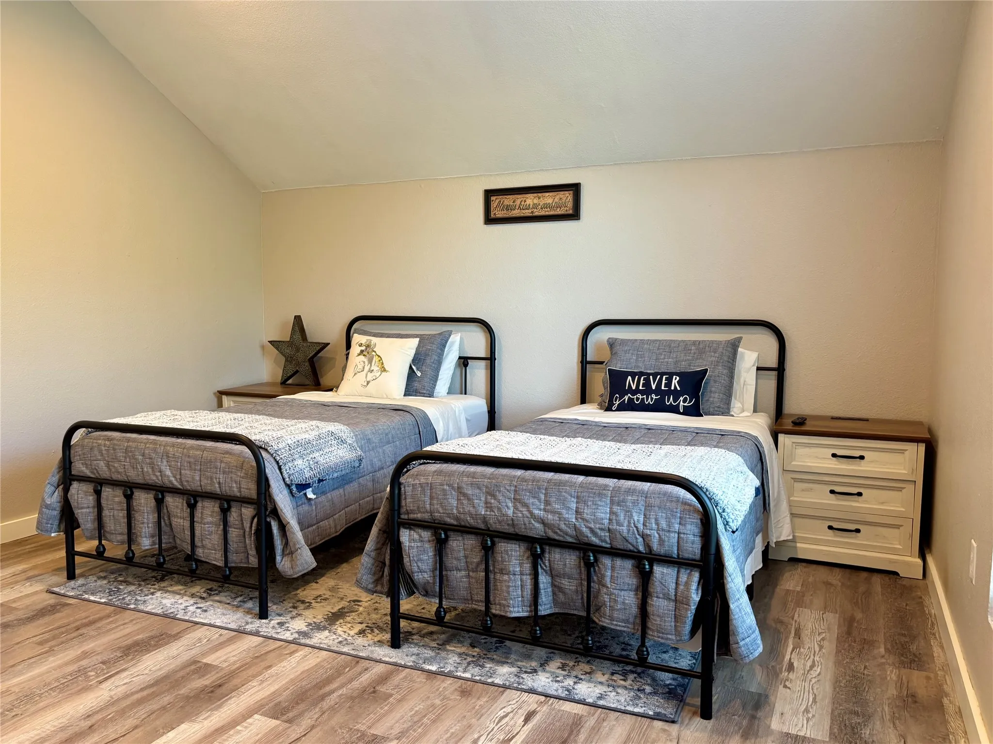 Vaulted ceiling, wood-finish flooring. Access to the balcony is through a bedroom door.