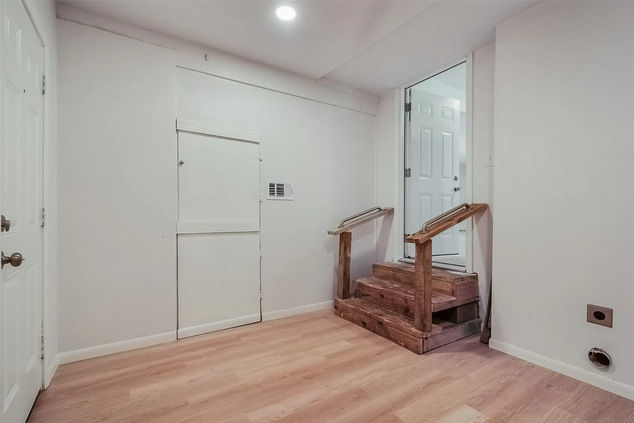 Wood-finish flooring with white walls