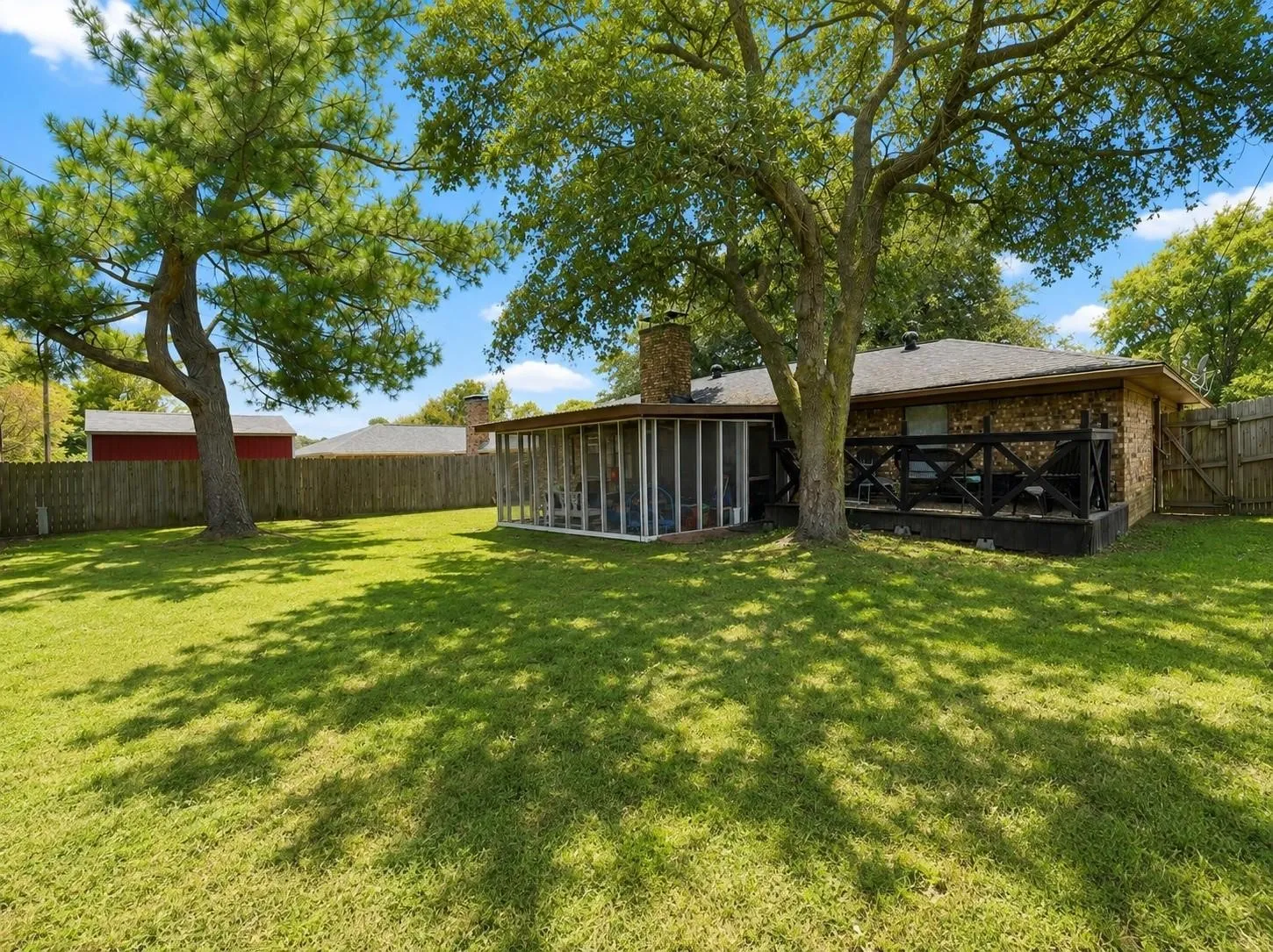 Large backyard with deck and screened in porch