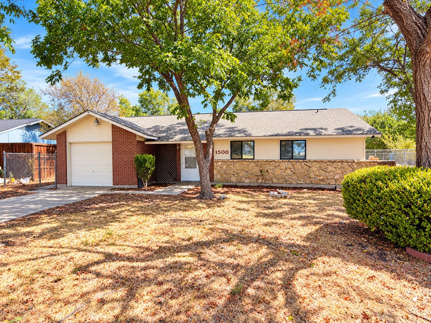 Brick and stucco exterior with a stone accent wall