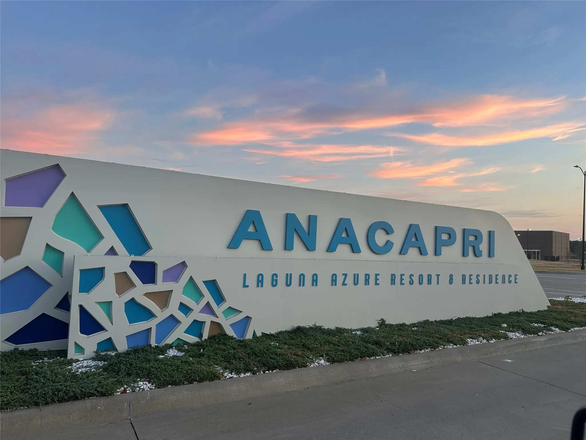 Custom-designed ANACAPRI monument sign with blue lettering and a mosaic-style base