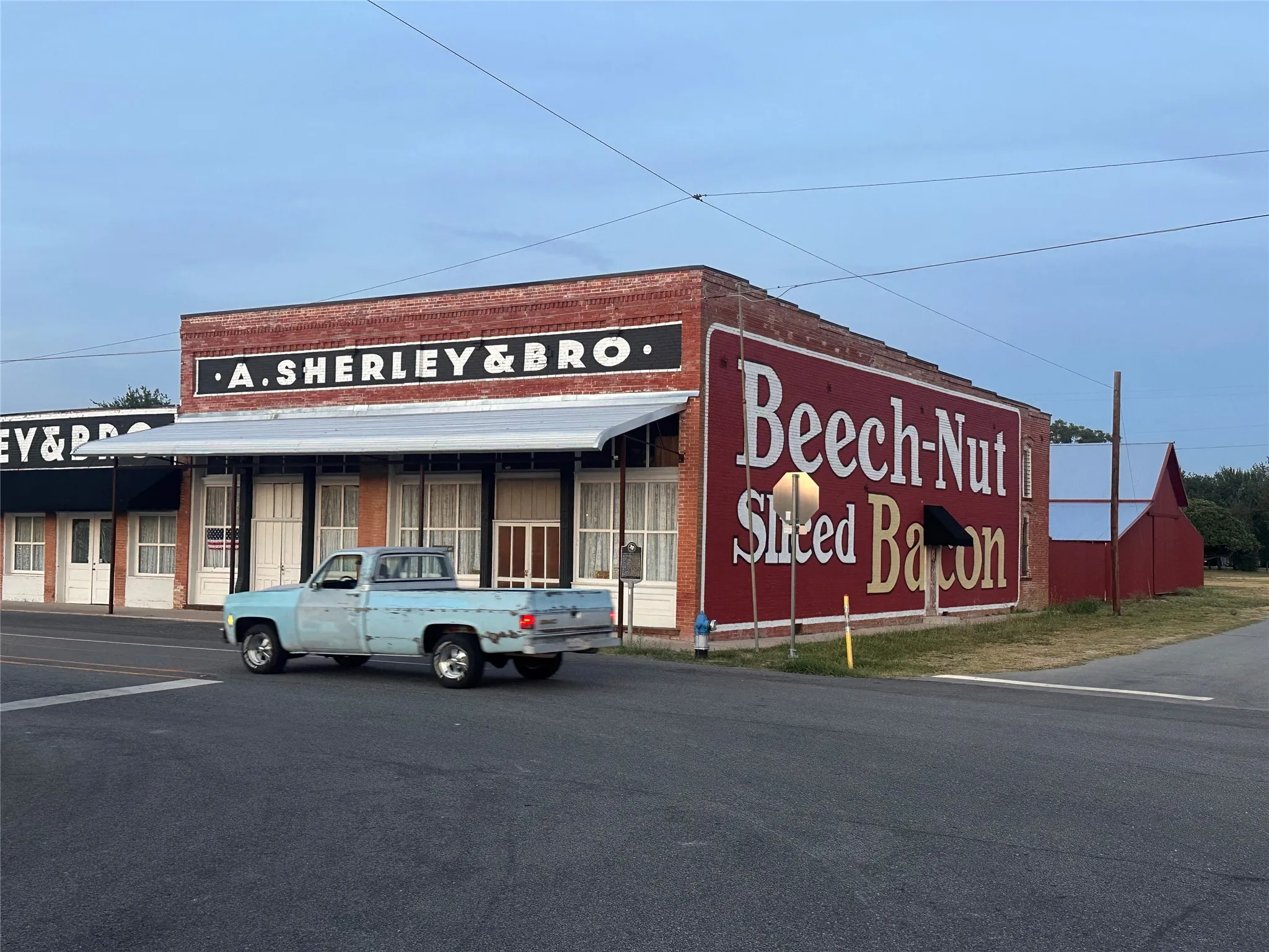 Brick storefront building featuring an awning