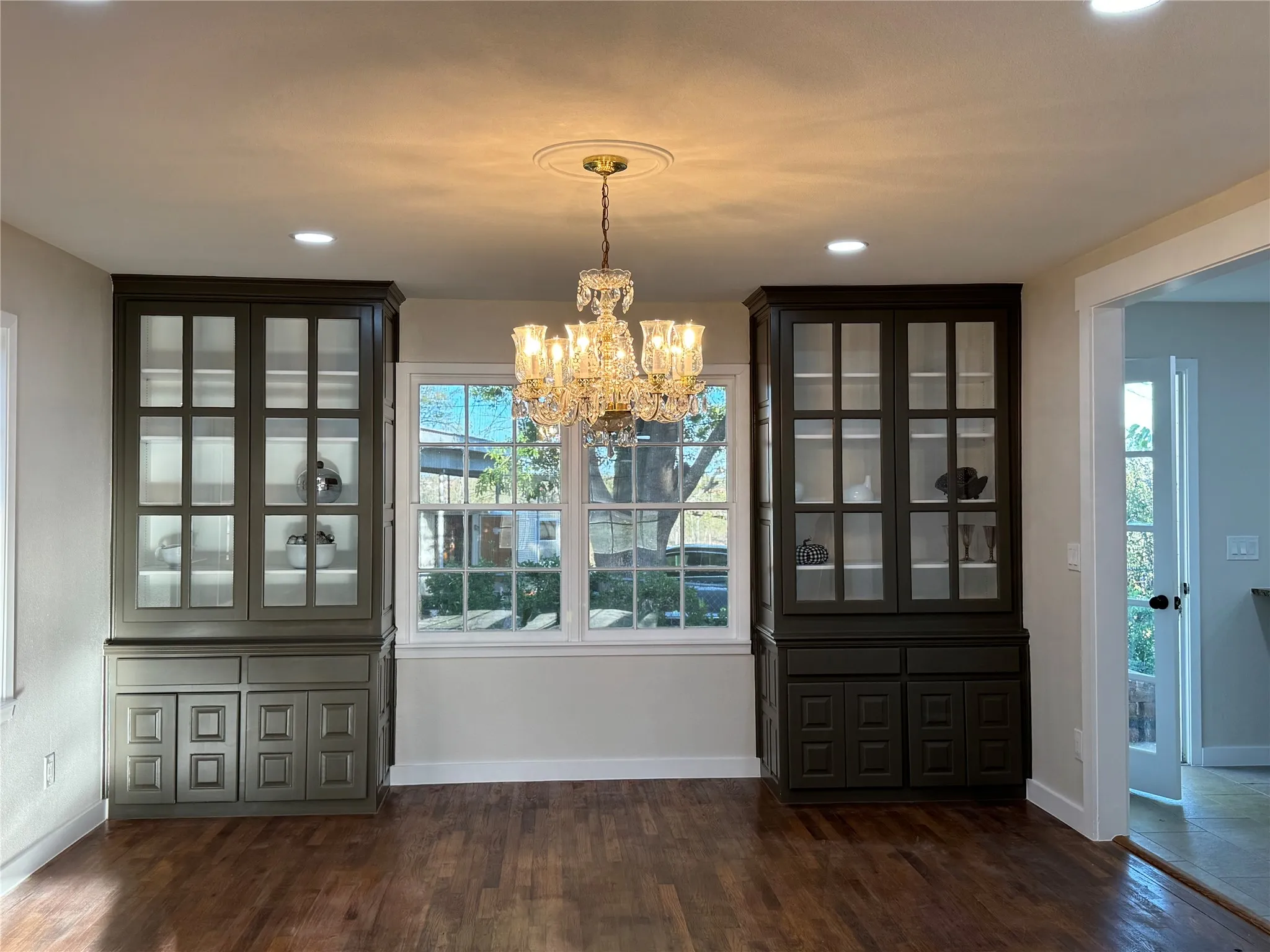 Unfurnished dining area with a chandelier and dark hardwood / wood-style floors