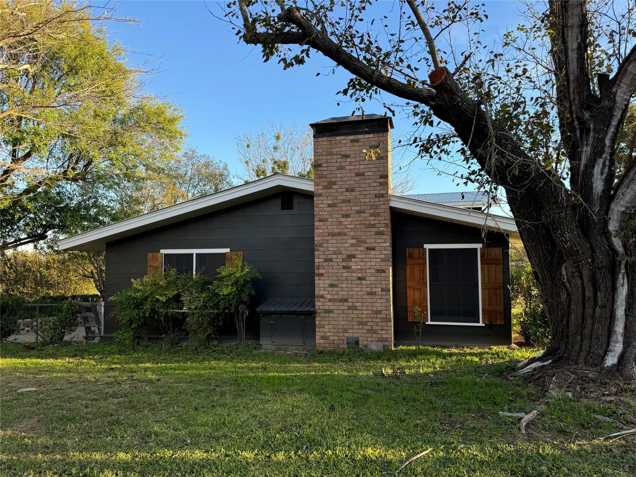Rear view of house featuring a yard