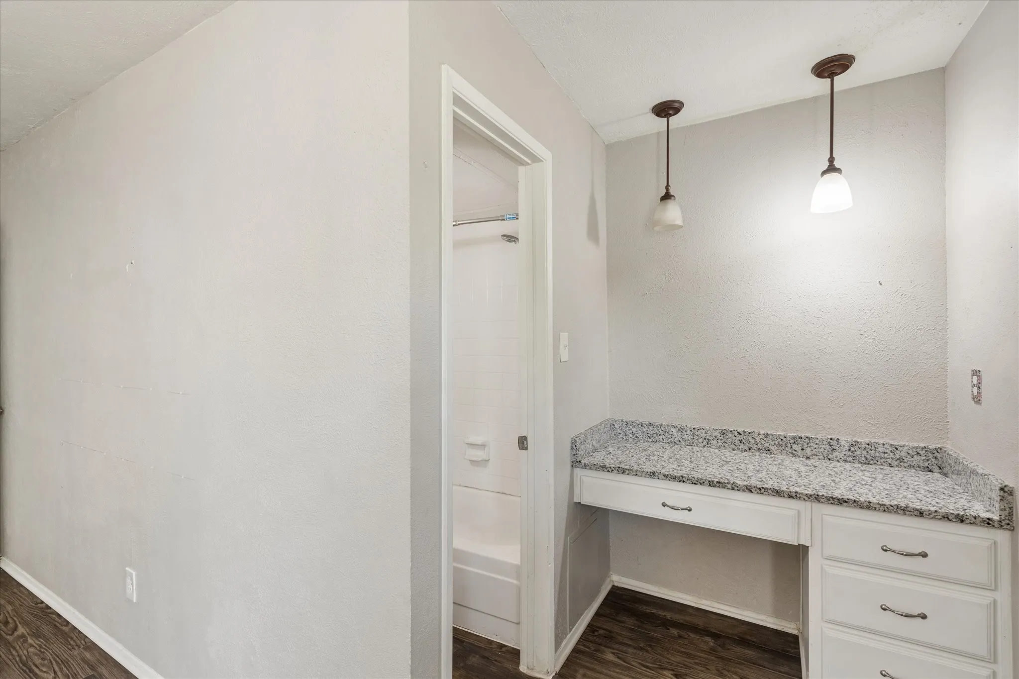 Bathroom with granite counters and a vanity area