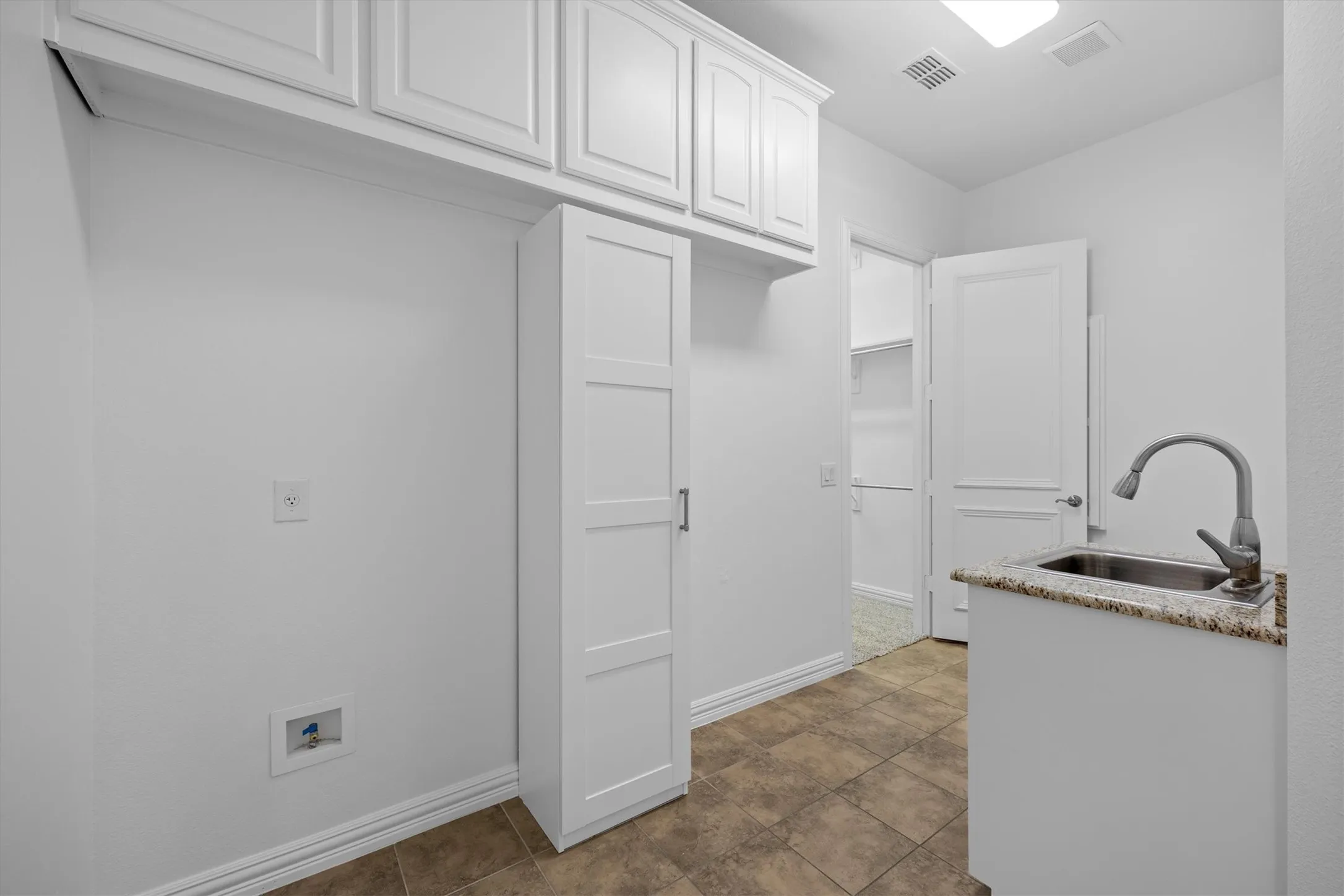 One of the primary closets leads to the laundry room for convenience!