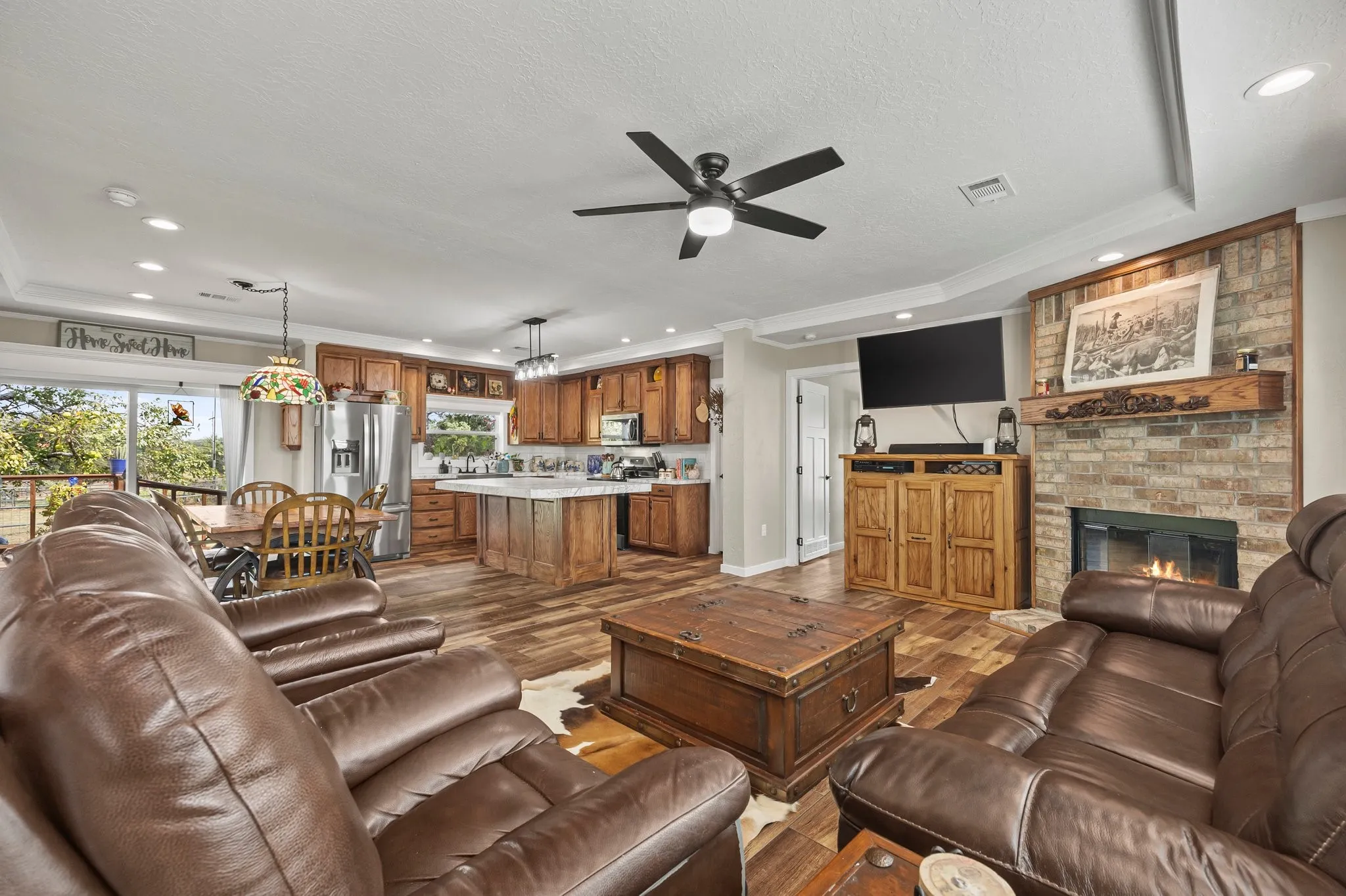 Spacious living room open to kitchen with wood burning fireplace