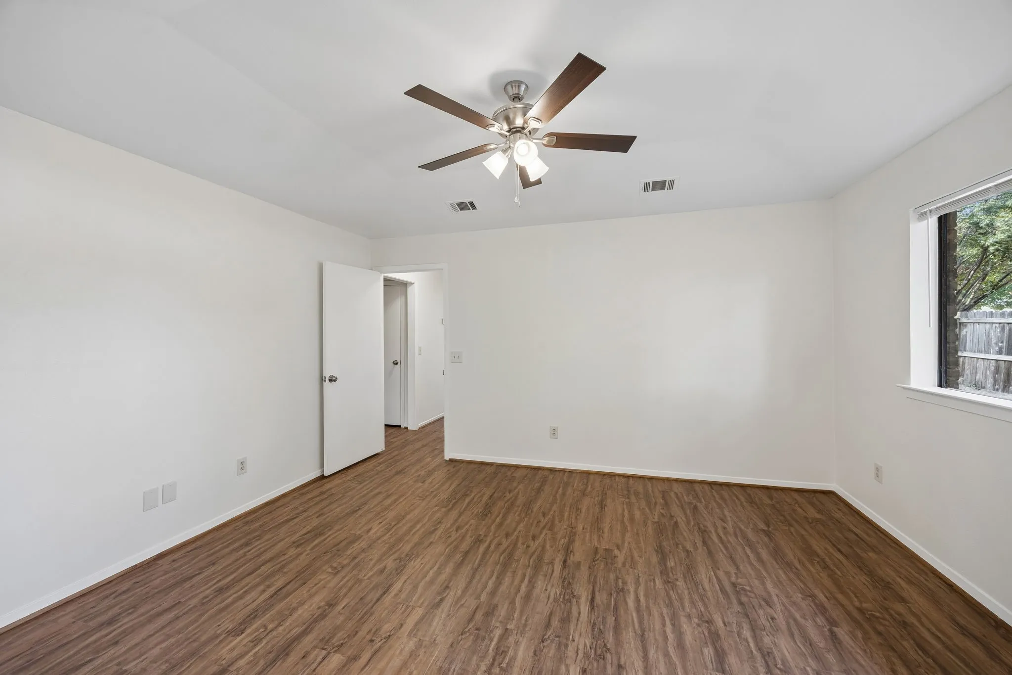 Wood-finish flooring with white walls and trim