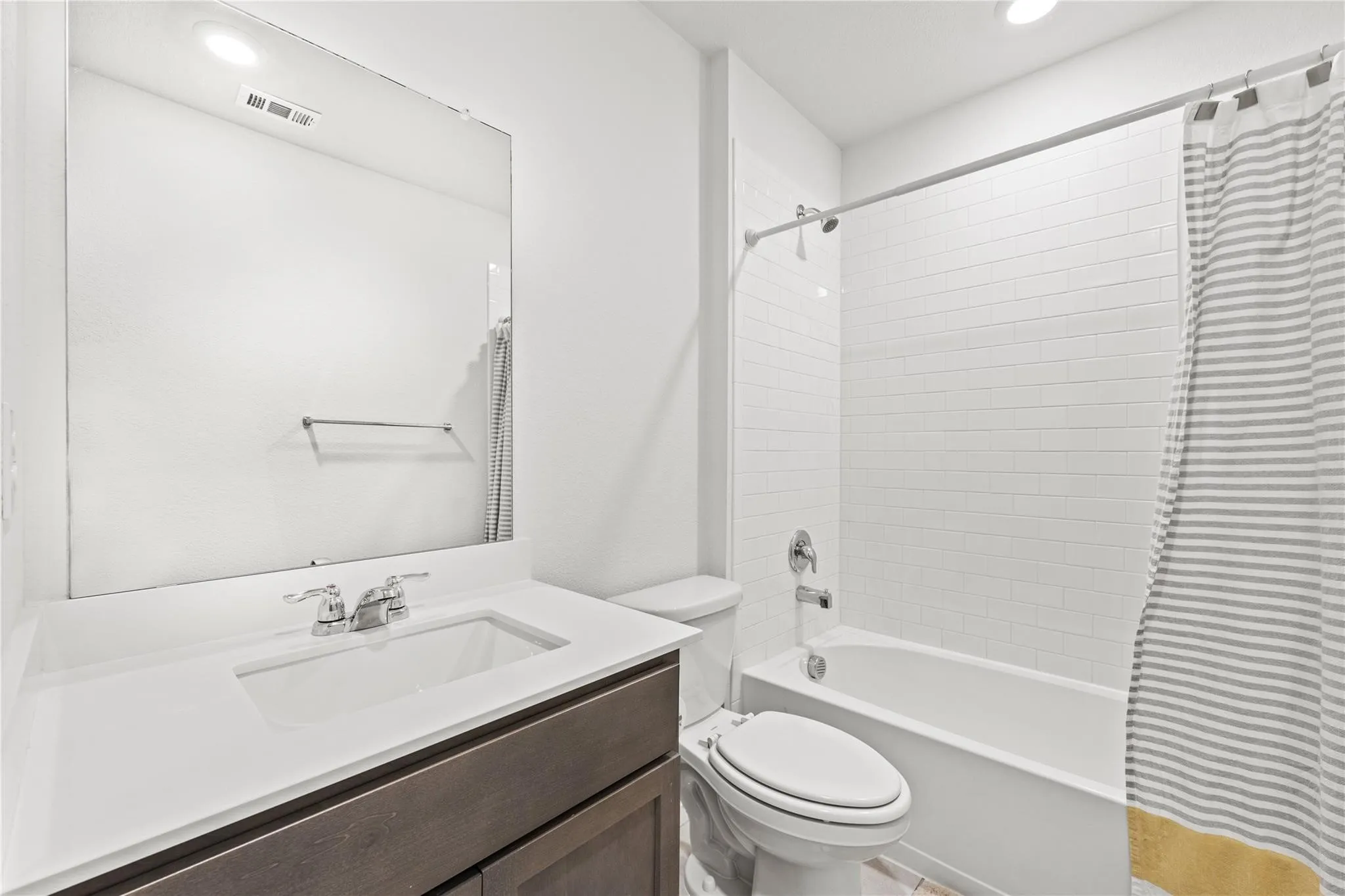 White subway tile shower surround with a built-in tub