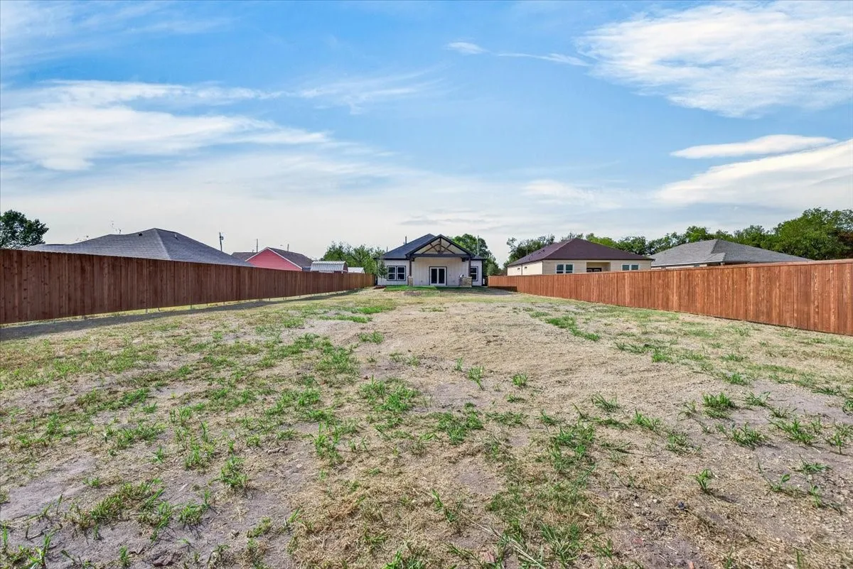 Expansive backyard area with new wood fencing, offering significant space for customization