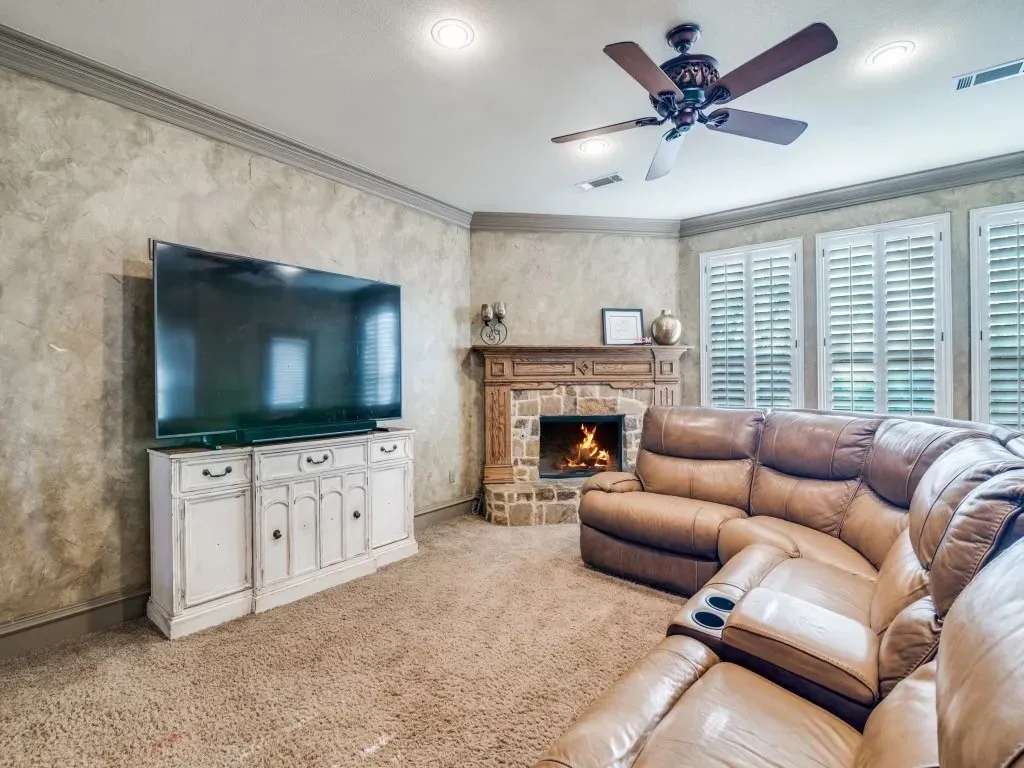 Corner fireplace with a stone surround and wood mantel