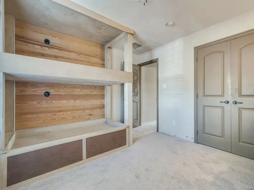Built-in bunk beds with wood-finish backing and integrated storage drawers