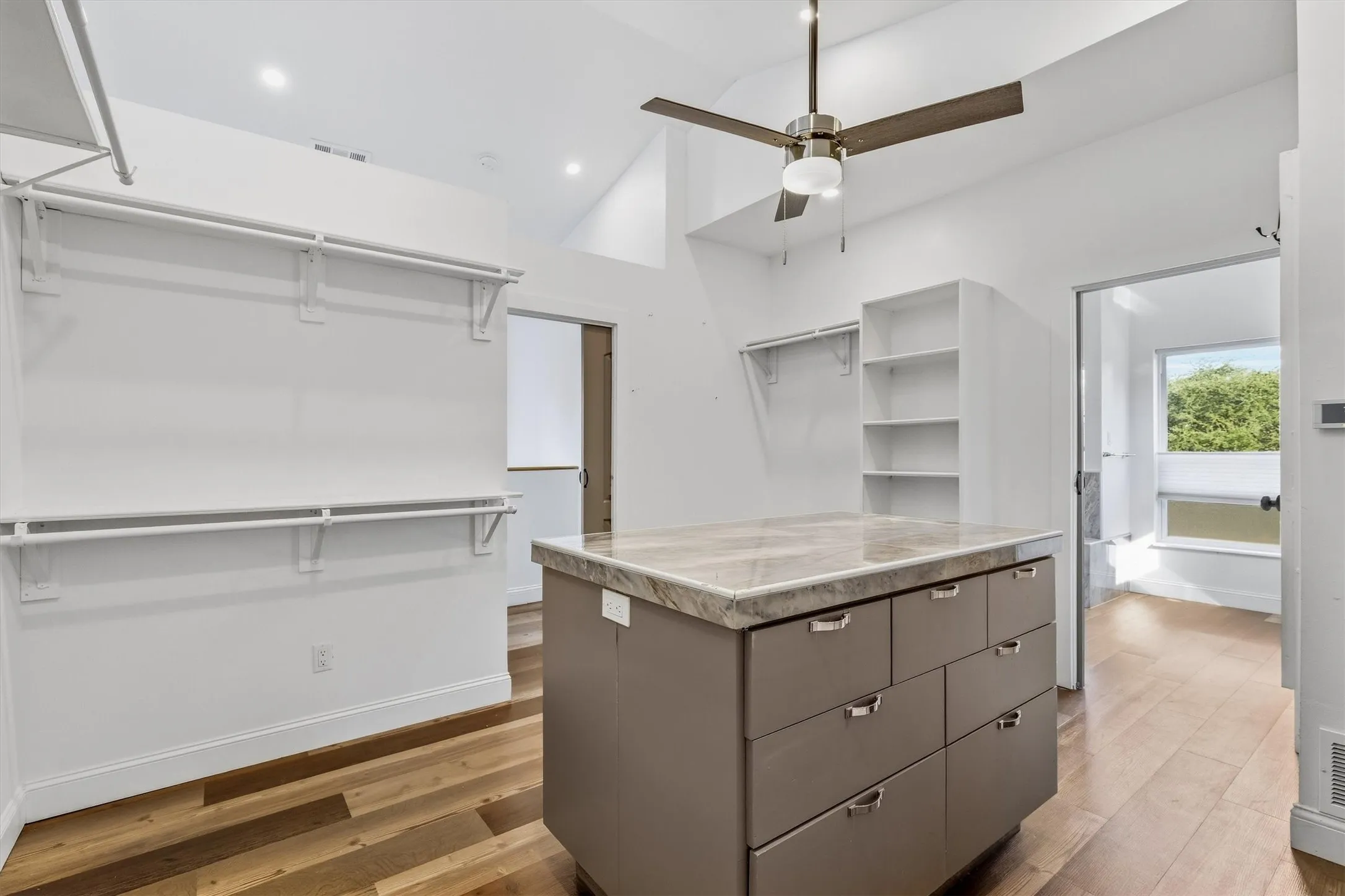 Wood-finish flooring, vaulted ceiling, and recessed lighting