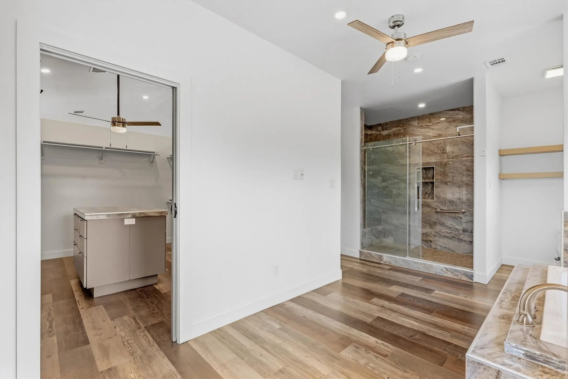 Wood-finish flooring throughout, with a built-in walk-in closet island and shelving