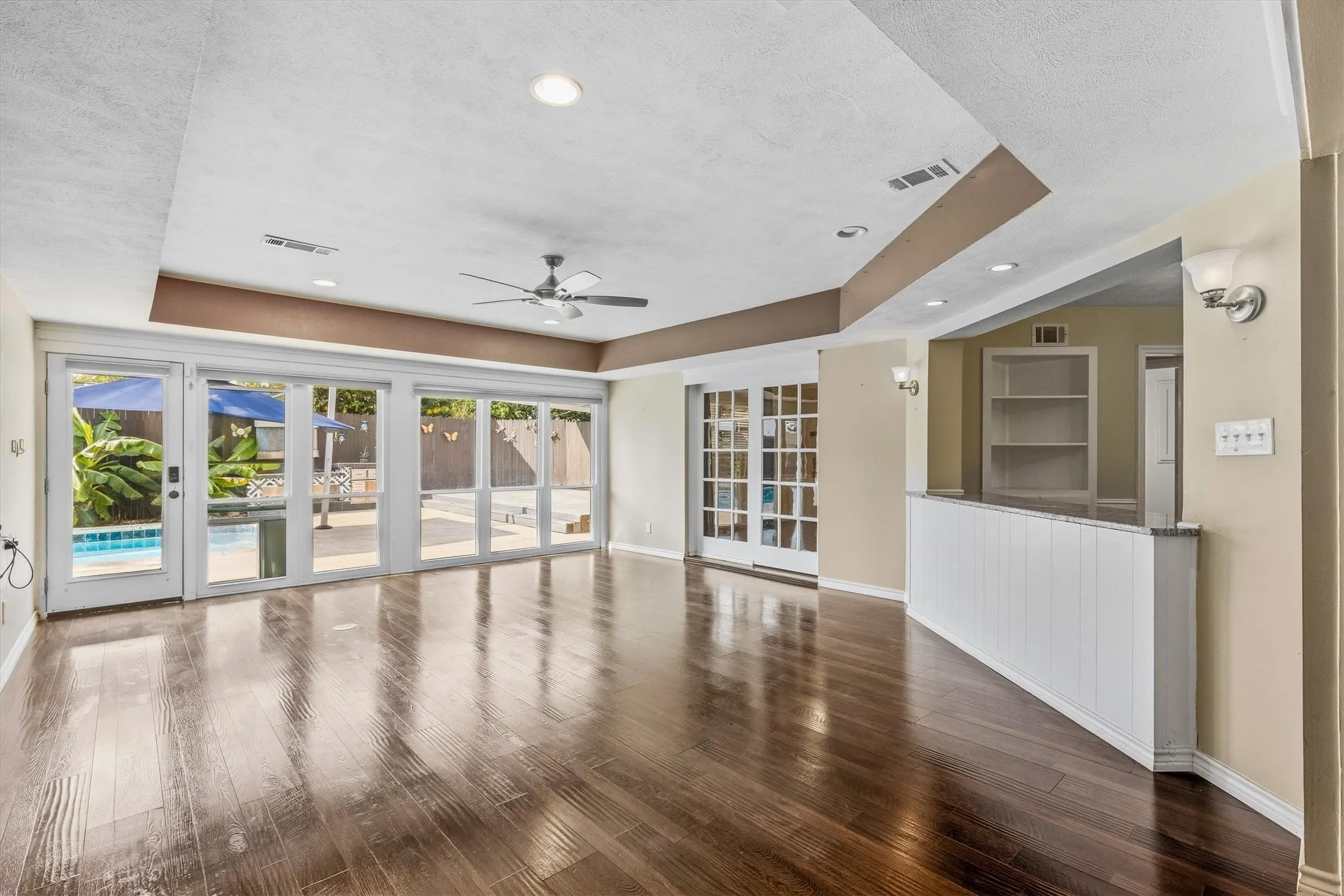 Wood-finish flooring throughout, recessed lighting, and a ceiling fan