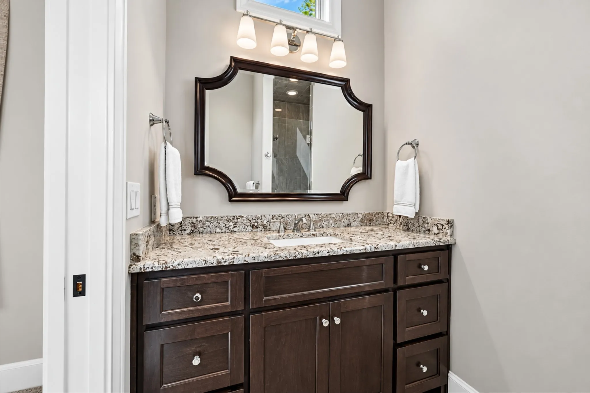 Rich wood-finish vanity with ample storage drawers and cabinet space