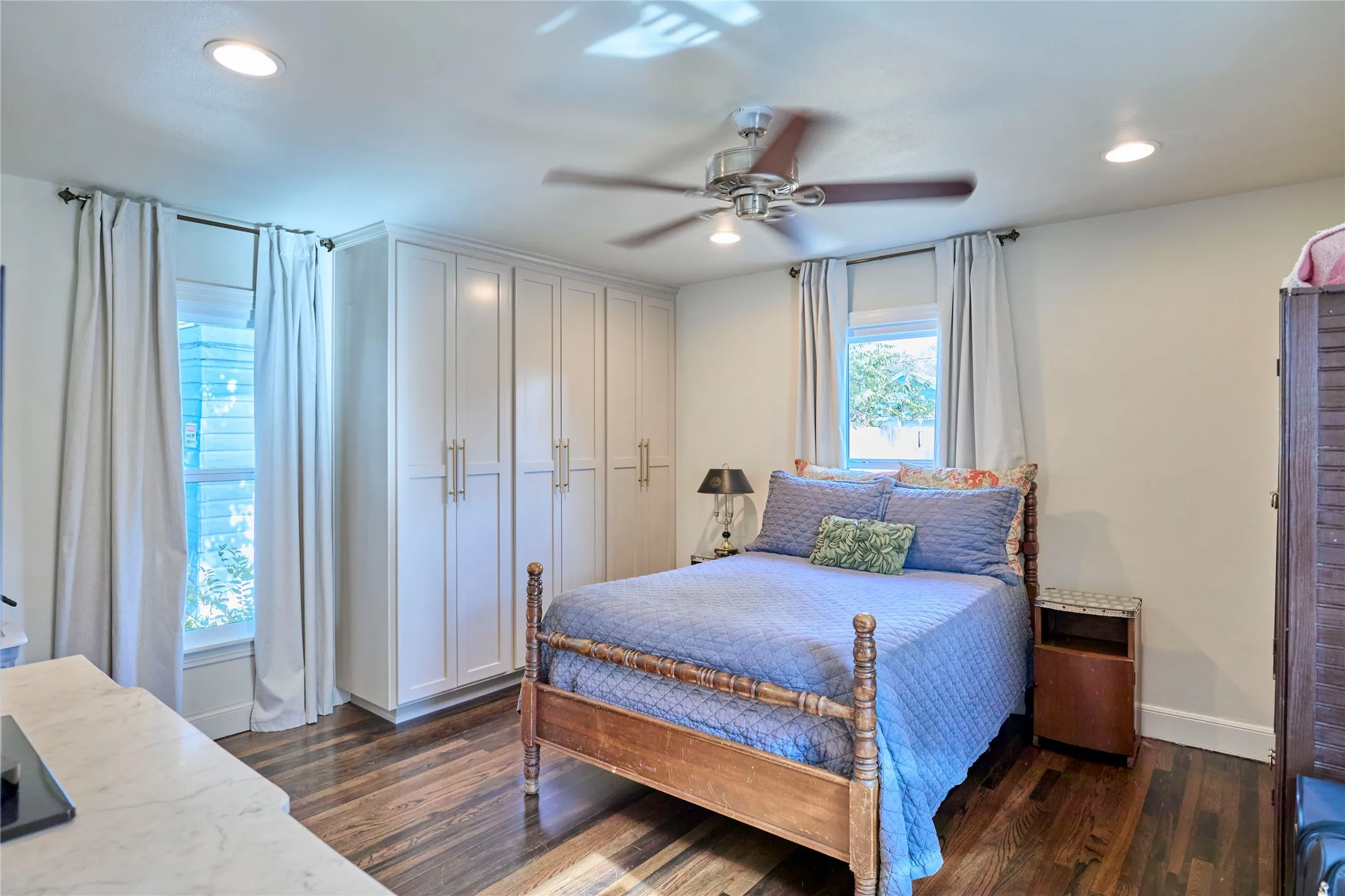 Wood-finish flooring throughout, complemented by a ceiling fan with integrated lighting