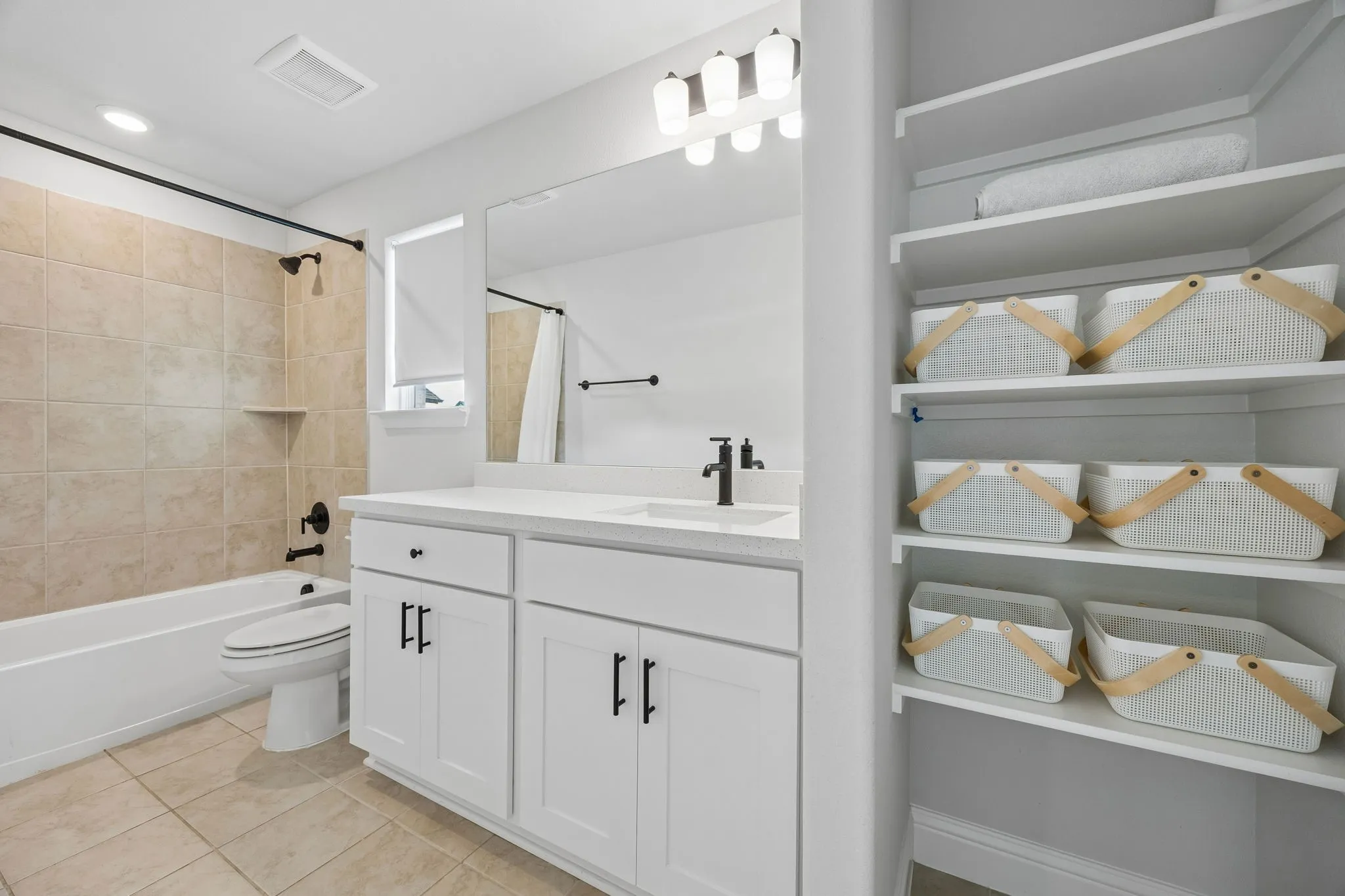 Vanity with white cabinetry, quartz countertop, and undermount sink