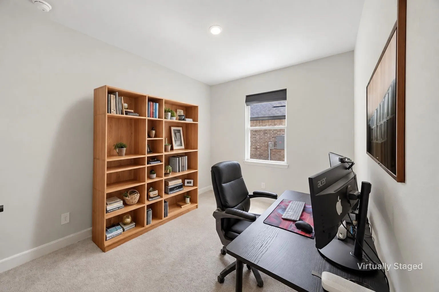 Recessed lighting, light-toned carpeting, and a window with a roller shade