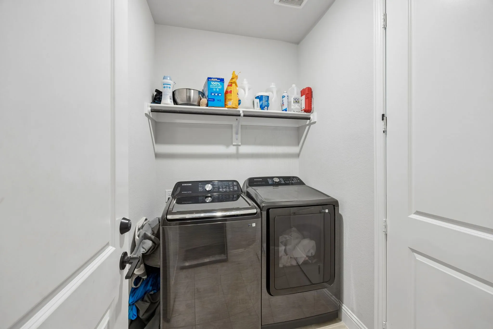 Dedicated laundry area with upper shelving