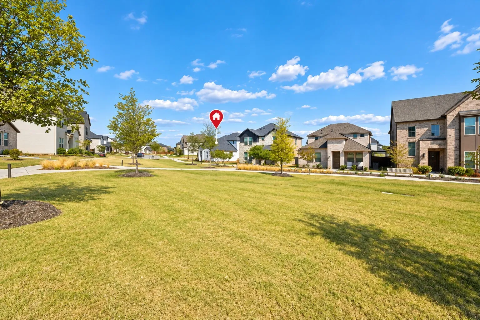 Expansive green space with walking paths, mature trees, and streetlights
