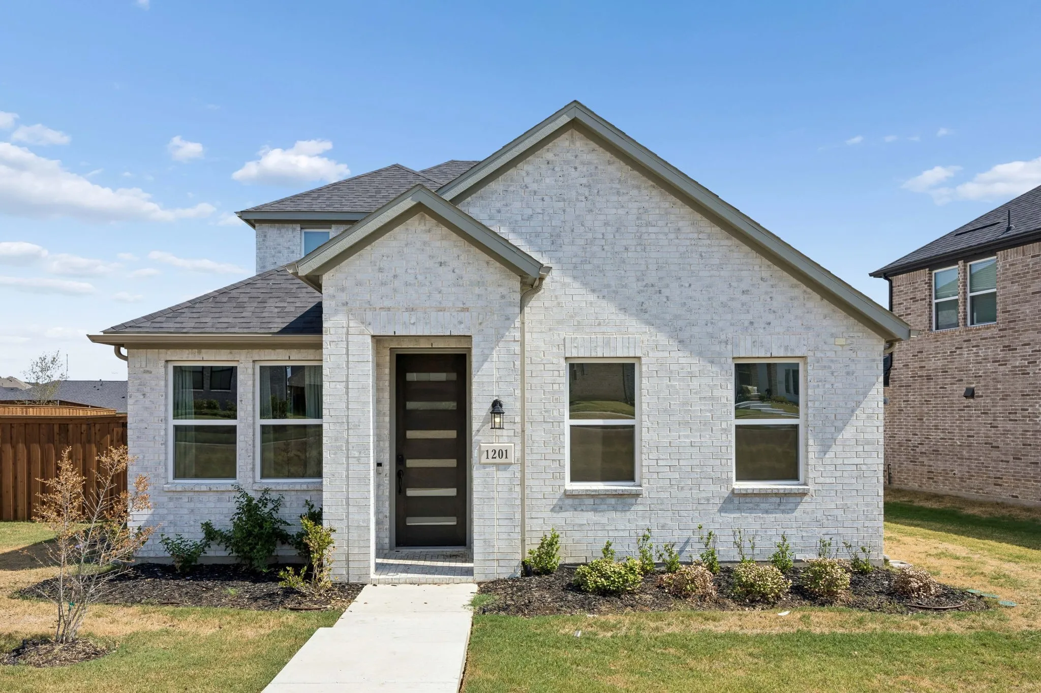 White brick exterior with dark gray trim