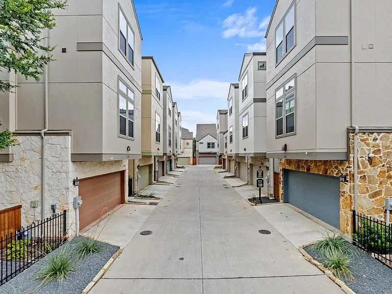 Contemporary townhome architecture featuring stucco and stone veneer exteriors