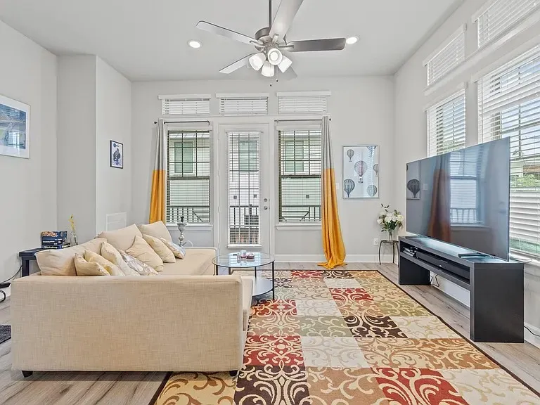 Living area featuring wood-finish flooring, recessed lighting, and a ceiling fan