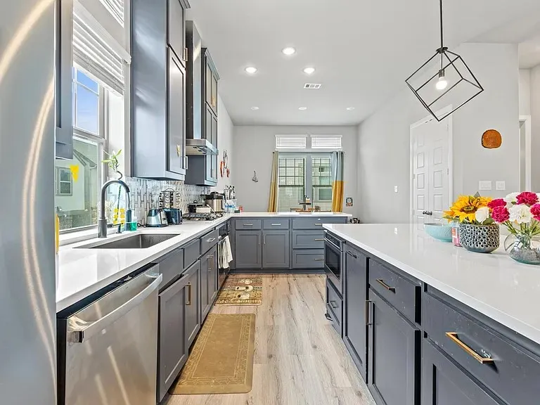 Kitchen with an expansive center island, gray cabinetry, light countertops, wood-finish flooring, and recessed lighting