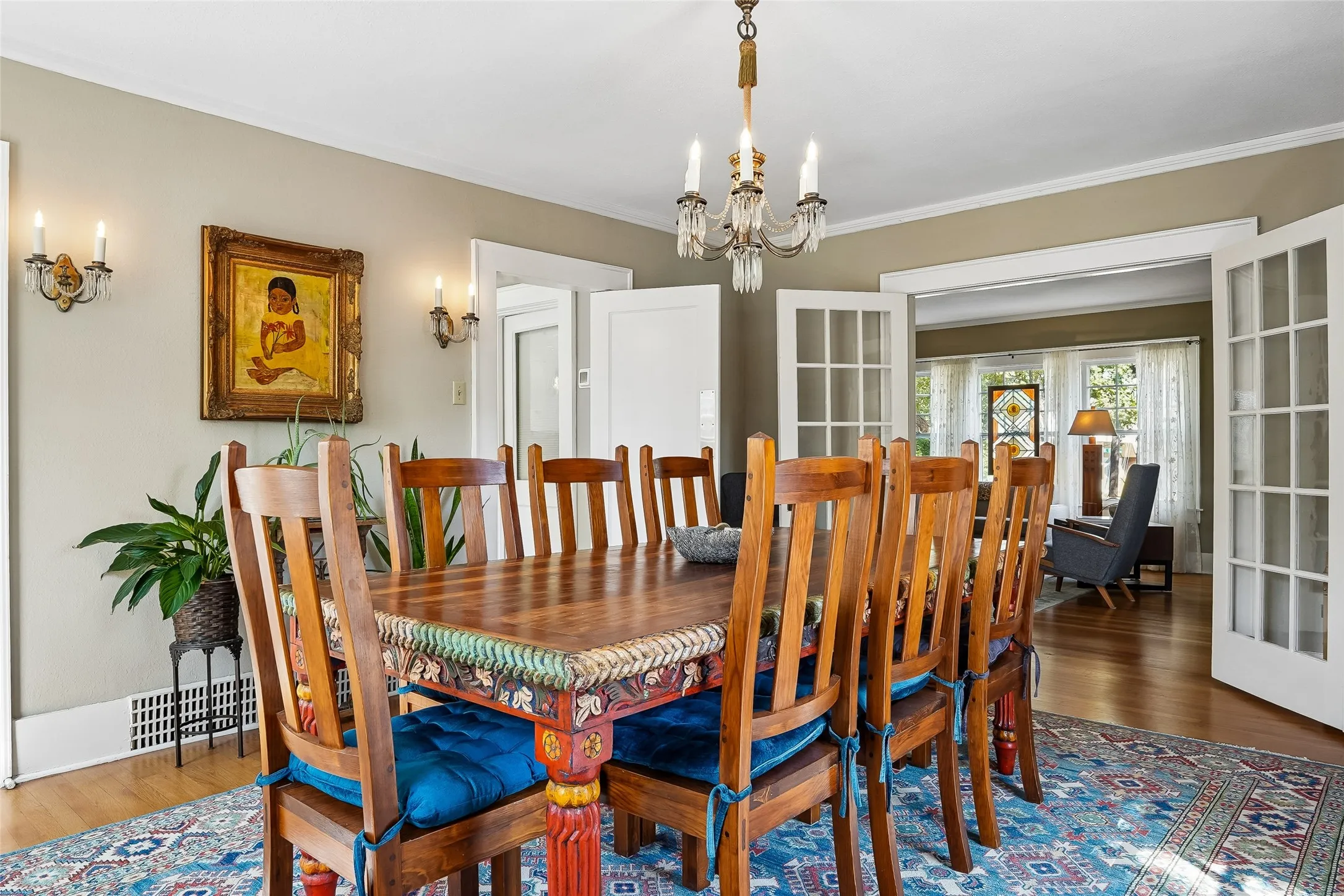 Hardwood flooring, chandelier, wall sconces, French doors, crown molding