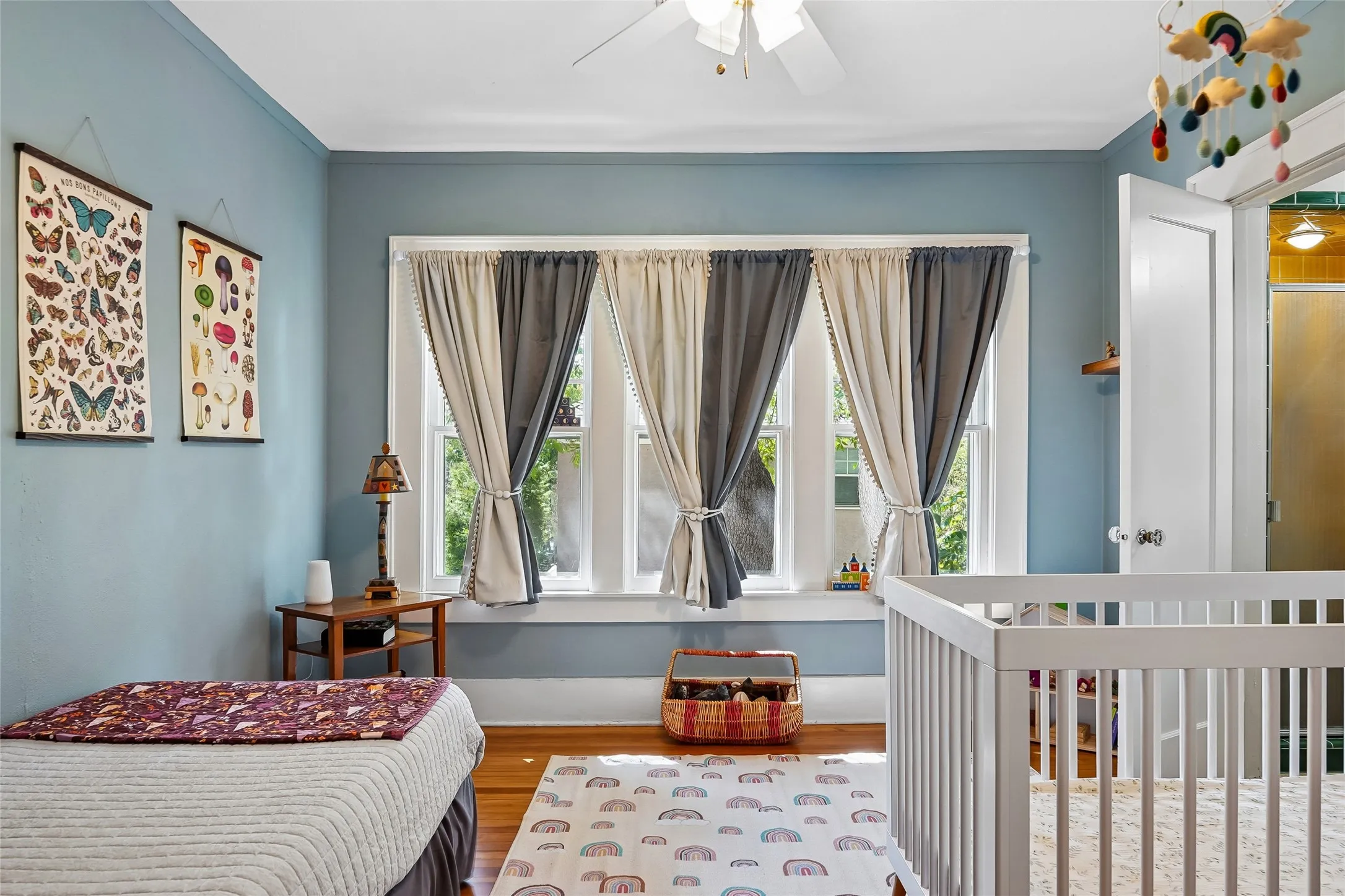 Hardwood flooring, multi-pane windows, ceiling fan, solid core door, and painted walls