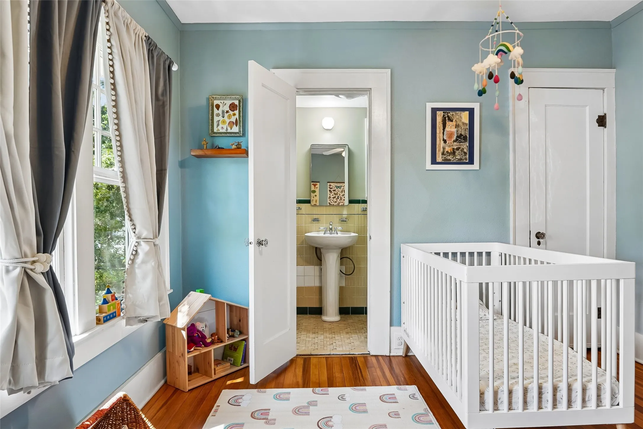 Hardwood flooring, painted walls, and a window with trim