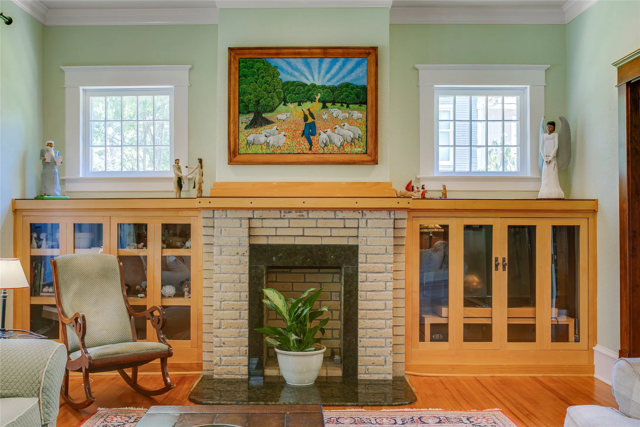 Formal living with fireplace framed by built-in bookcases
