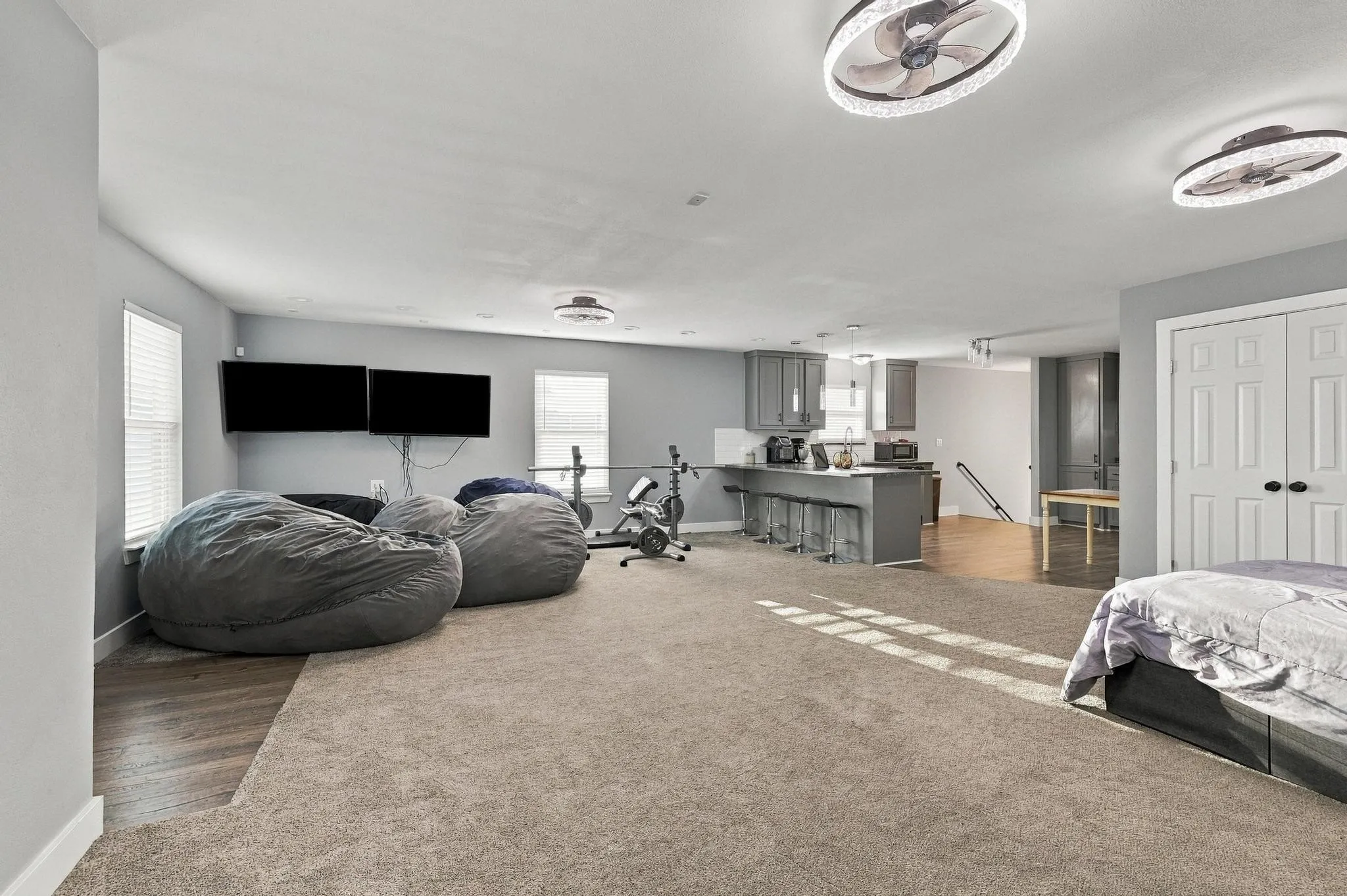 Second Floor Recessed lighting, wood-finish flooring, light grey walls, white paneled doors, and ceiling-mounted fans