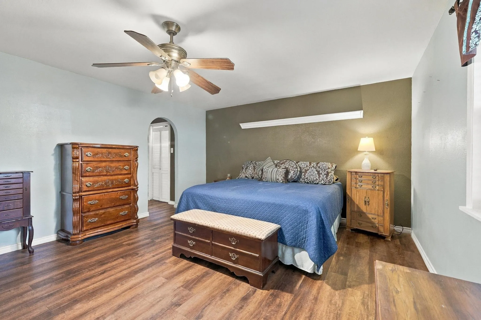 Primary Bedroom with  arched doorway leading to primary bath