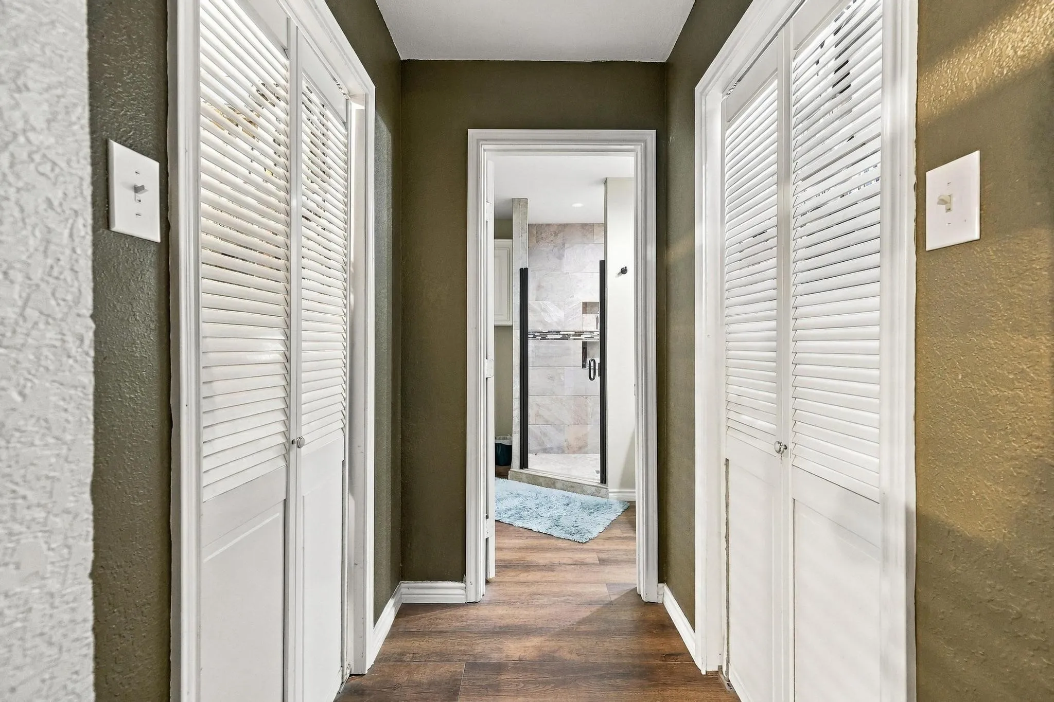 Hallway from Primary Bedroom leading to closets and primary bath