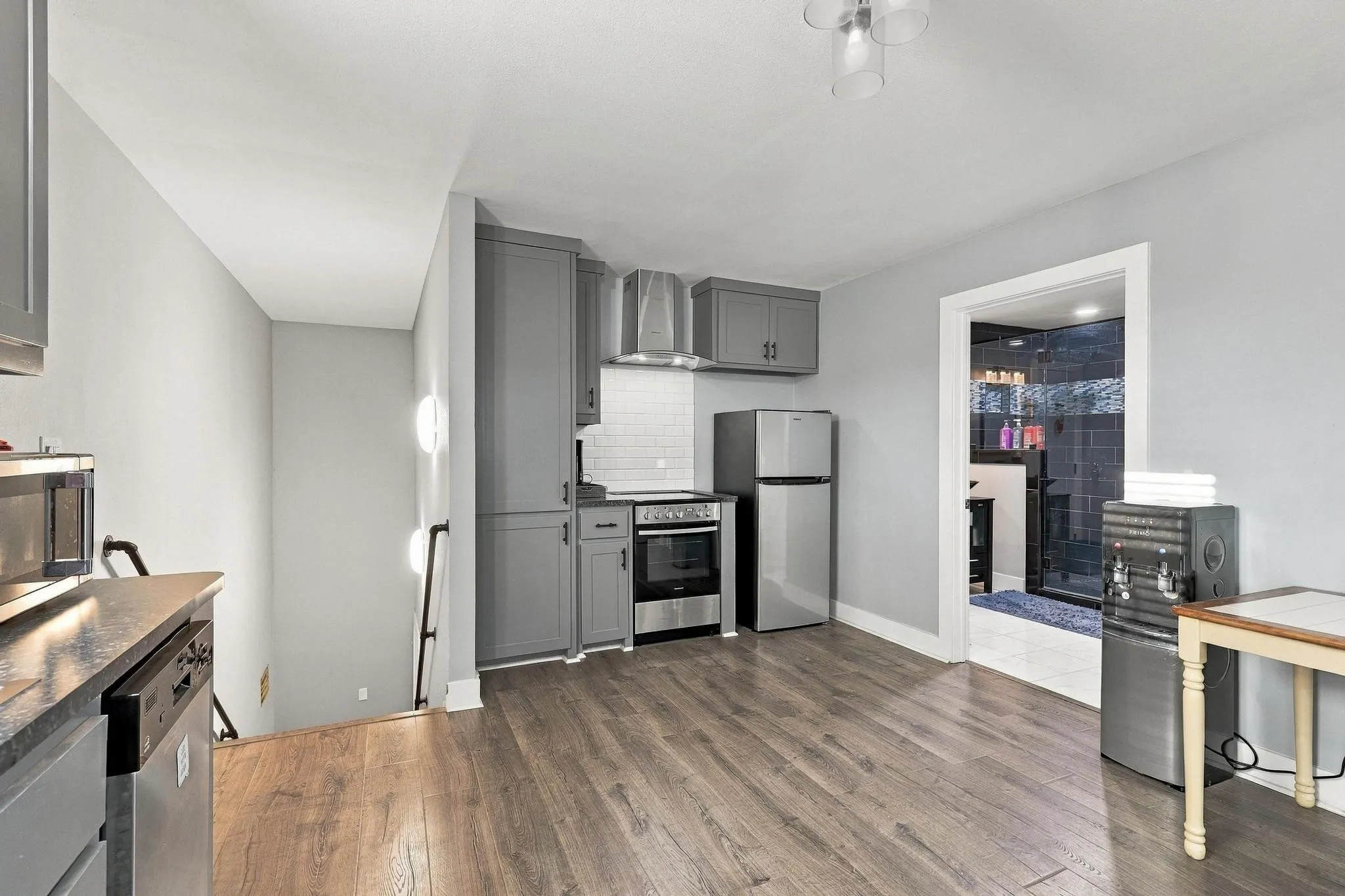 Second floor Kitchen area complemented by grey cabinetry and stainless steel appliances