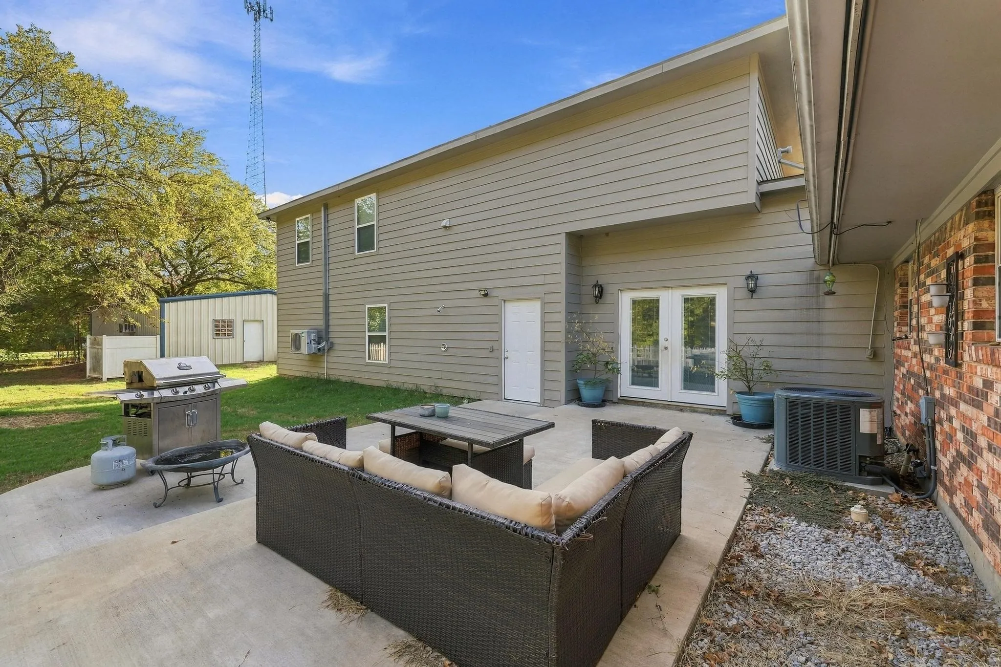 Expansive concrete patio with direct access to interior via french doors