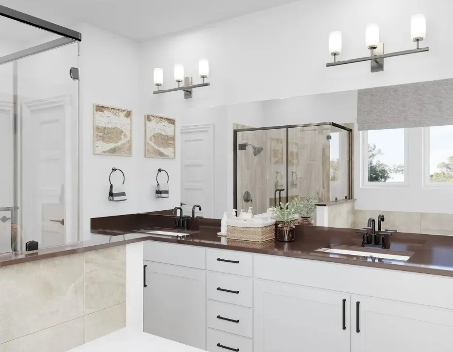 Dual vanities with dark countertops, white cabinetry, and matte black fixtures